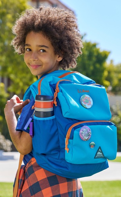 Young child wearing a Trailfinder Backpack.