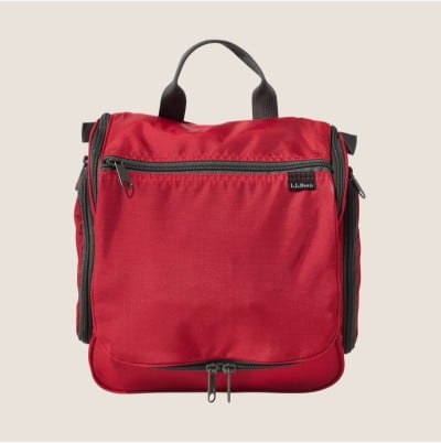 Red L.L.Bean travel toiletry bag with top handles, front zipper pocket, and side compartments.