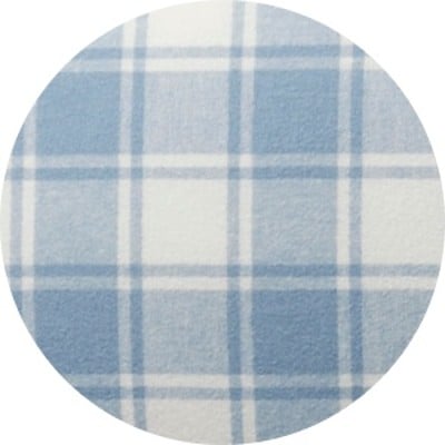 A circular swatch of a blue plaid bed sheet.