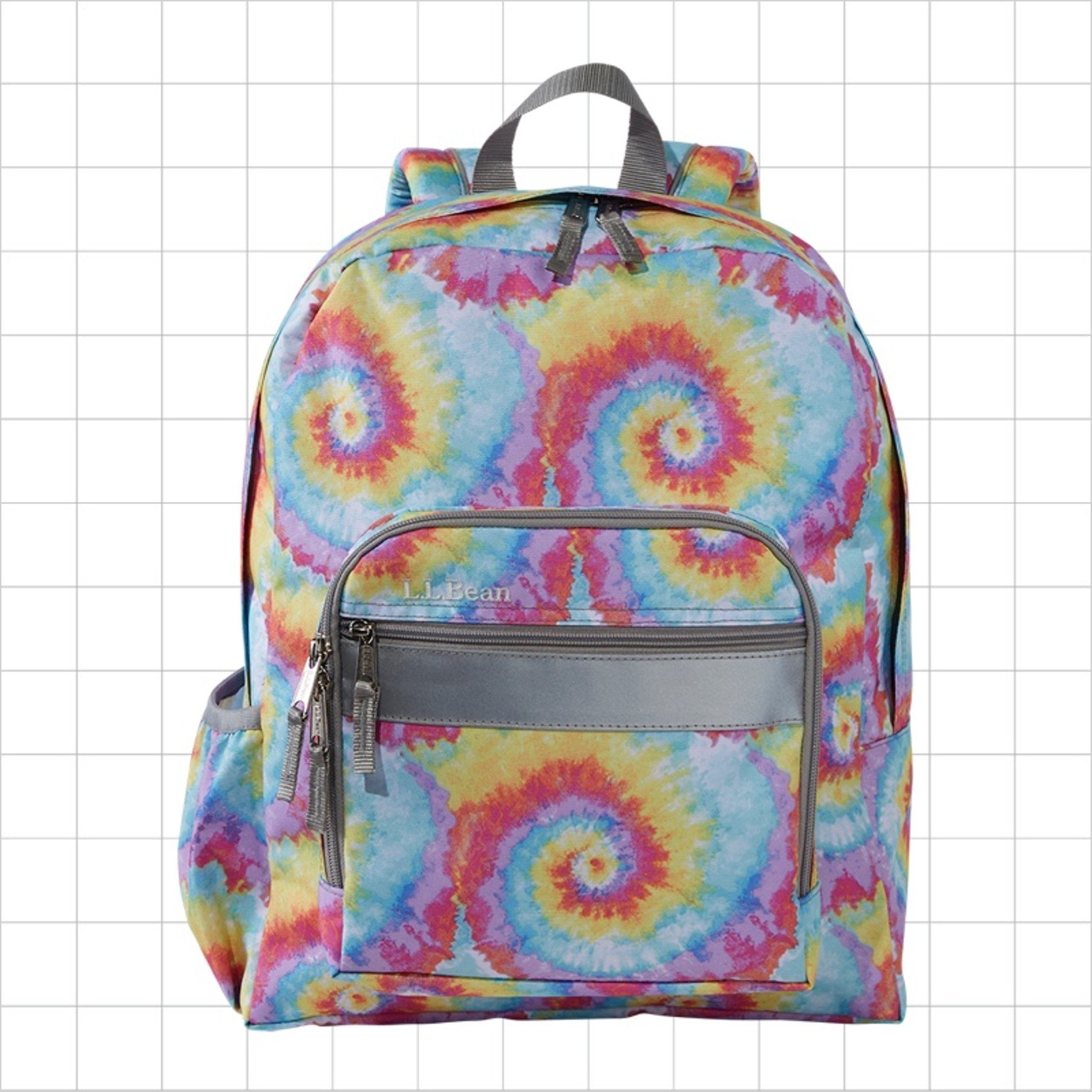 A tie-dye patterned school backpack with a reflective strip on the front pocket.