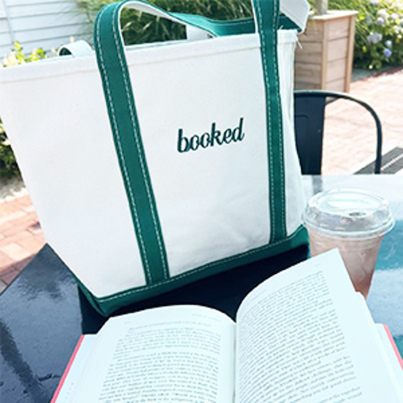 White tote with green straps labeled 