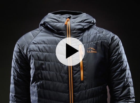 Black L L Bean puffer jacket with orange zippers shown against a dark background. Orange L L Bean logo visible on chest.