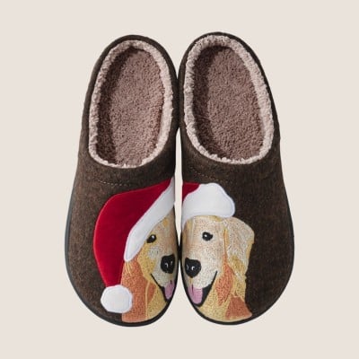 Brown slippers with fleece lining and dog wearing a Santa hat embroidered on top.