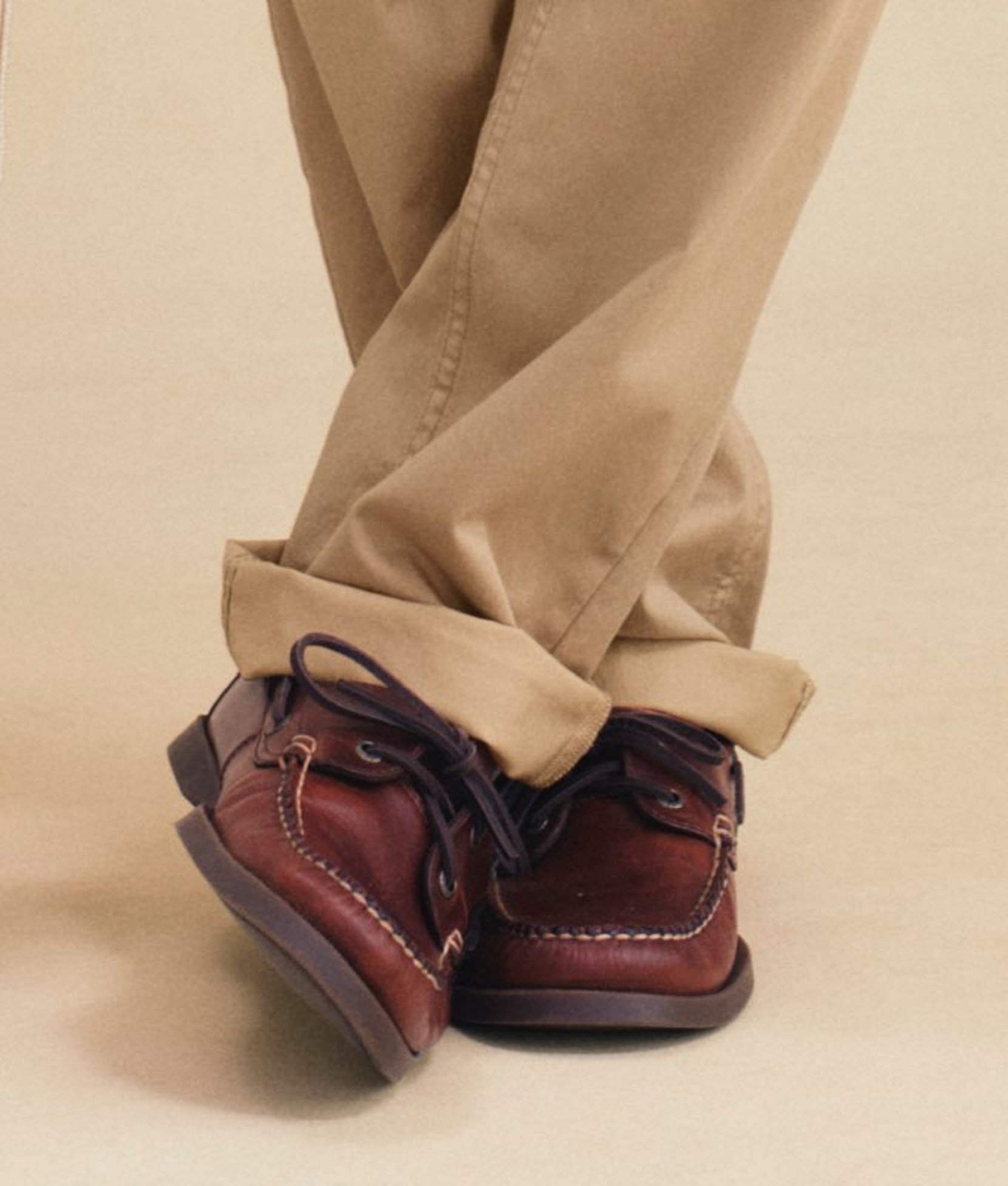 Men’s brown shoes shown with tan pants. 