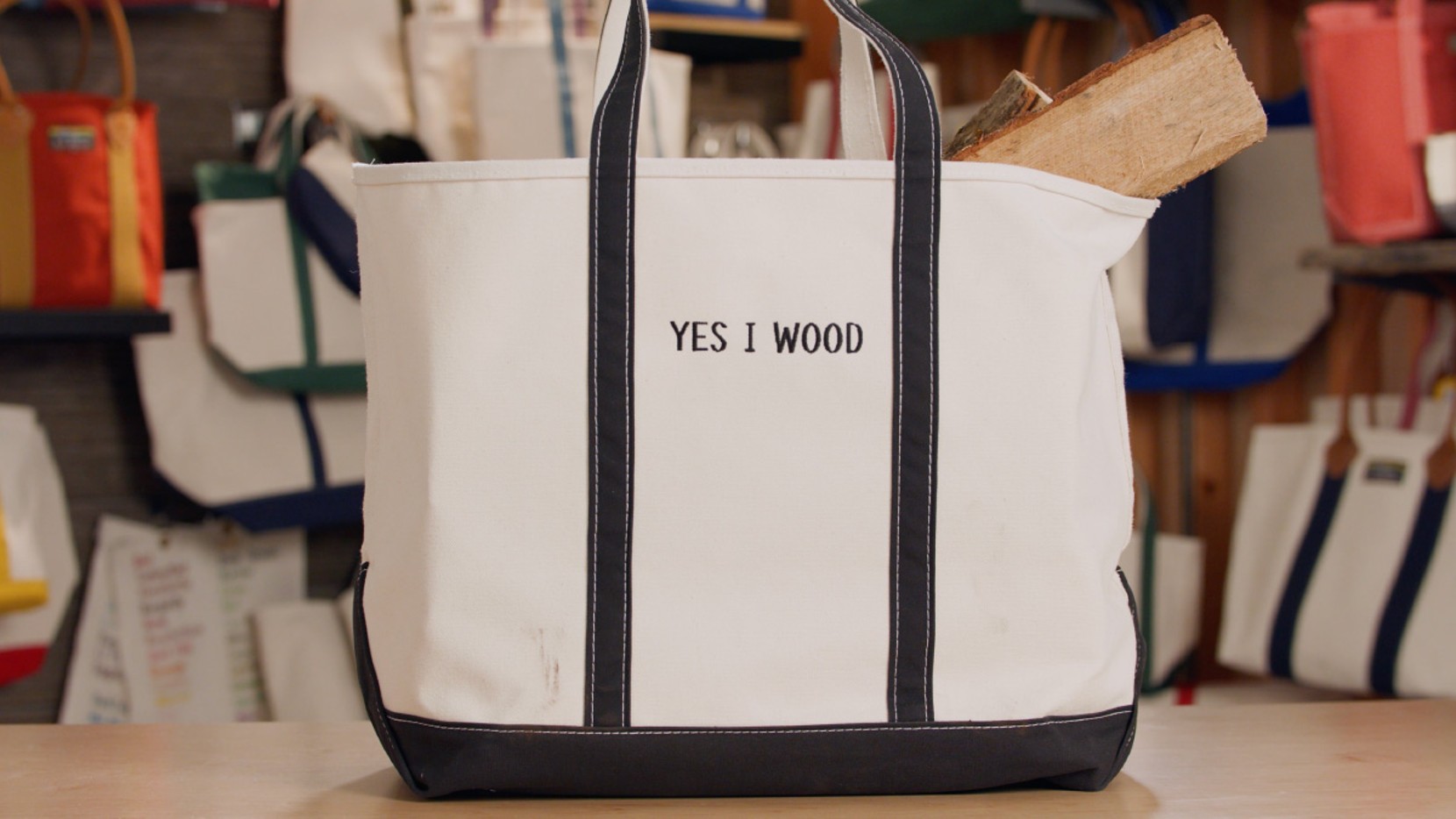 A Boat & Tote with black handles and a black monogram - YES I WOOD