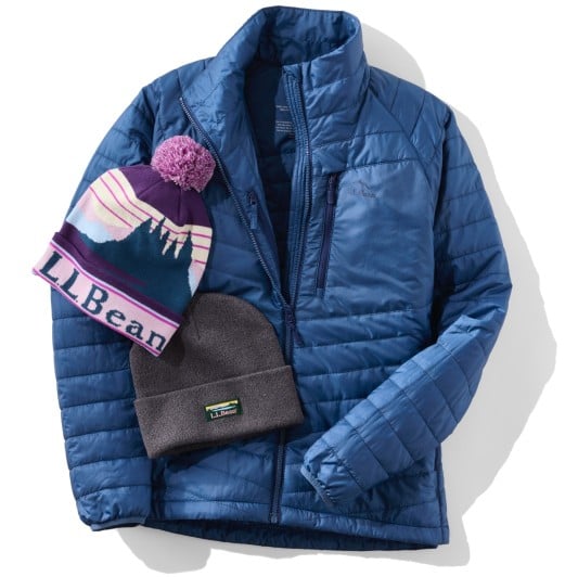 Blue quilted jacket with two winter hats on top: a purple L L Bean beanie and a plain gray fleece beanie.