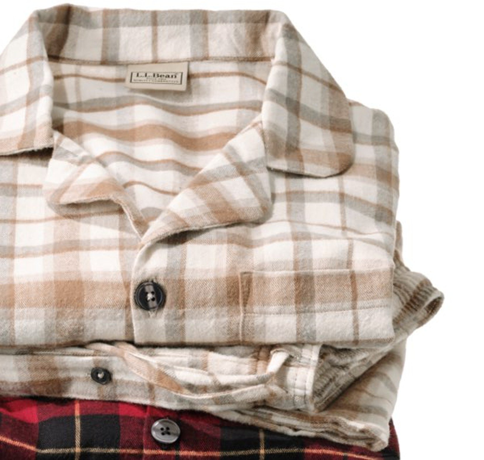 Folded men’s flannel pajamas in a neutral plaid pattern. 