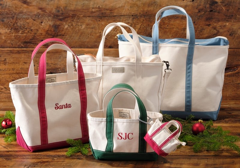 Five canvas tote bags embroidered with "Santa" and initials "SJC"