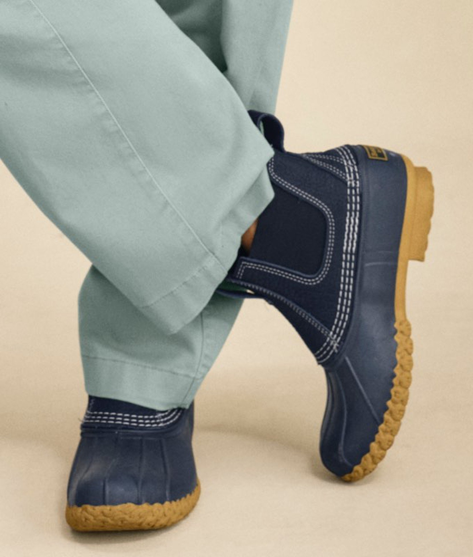 Close-up of navy ankle boots with thick soles.