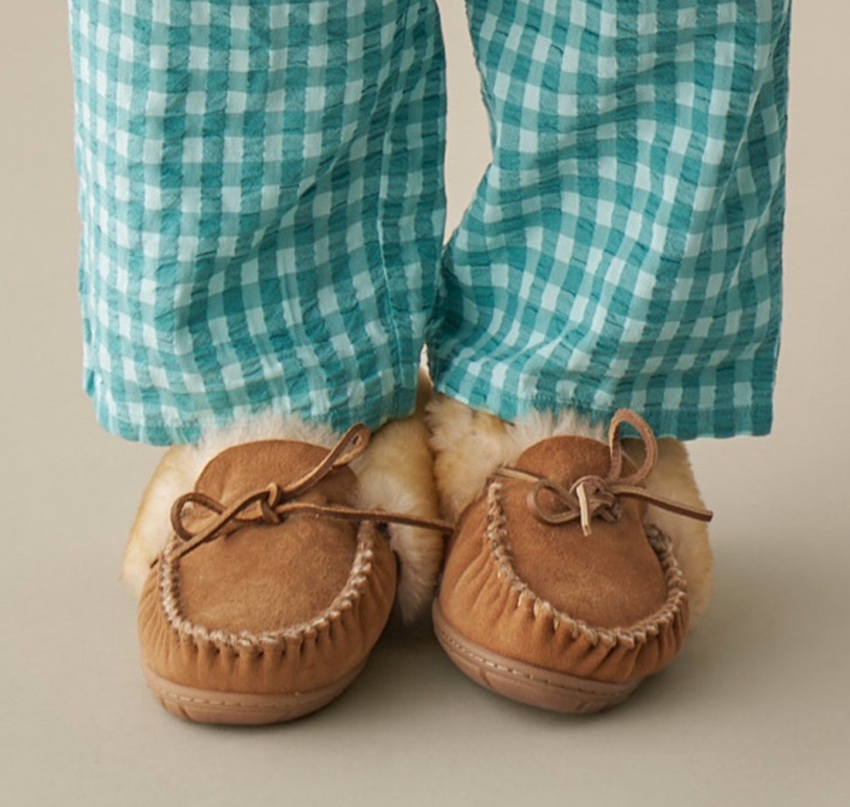 Shin down shot of a woman wearing pajama bottoms and Wicked Good Slippers.