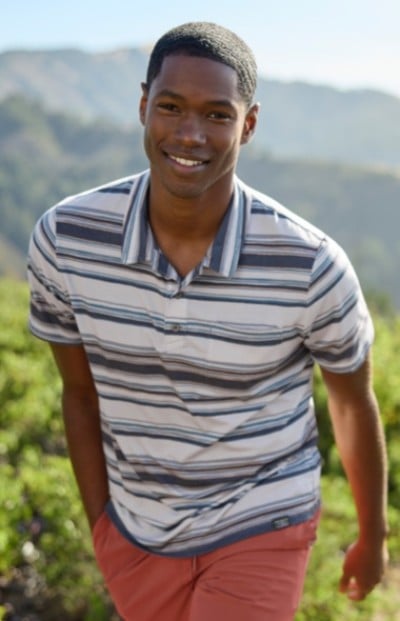 Waist up shot of man in multicolor striped shirt.
