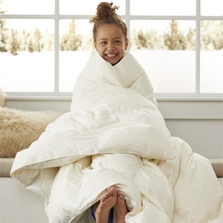 Young girl wrapped in a comforter
